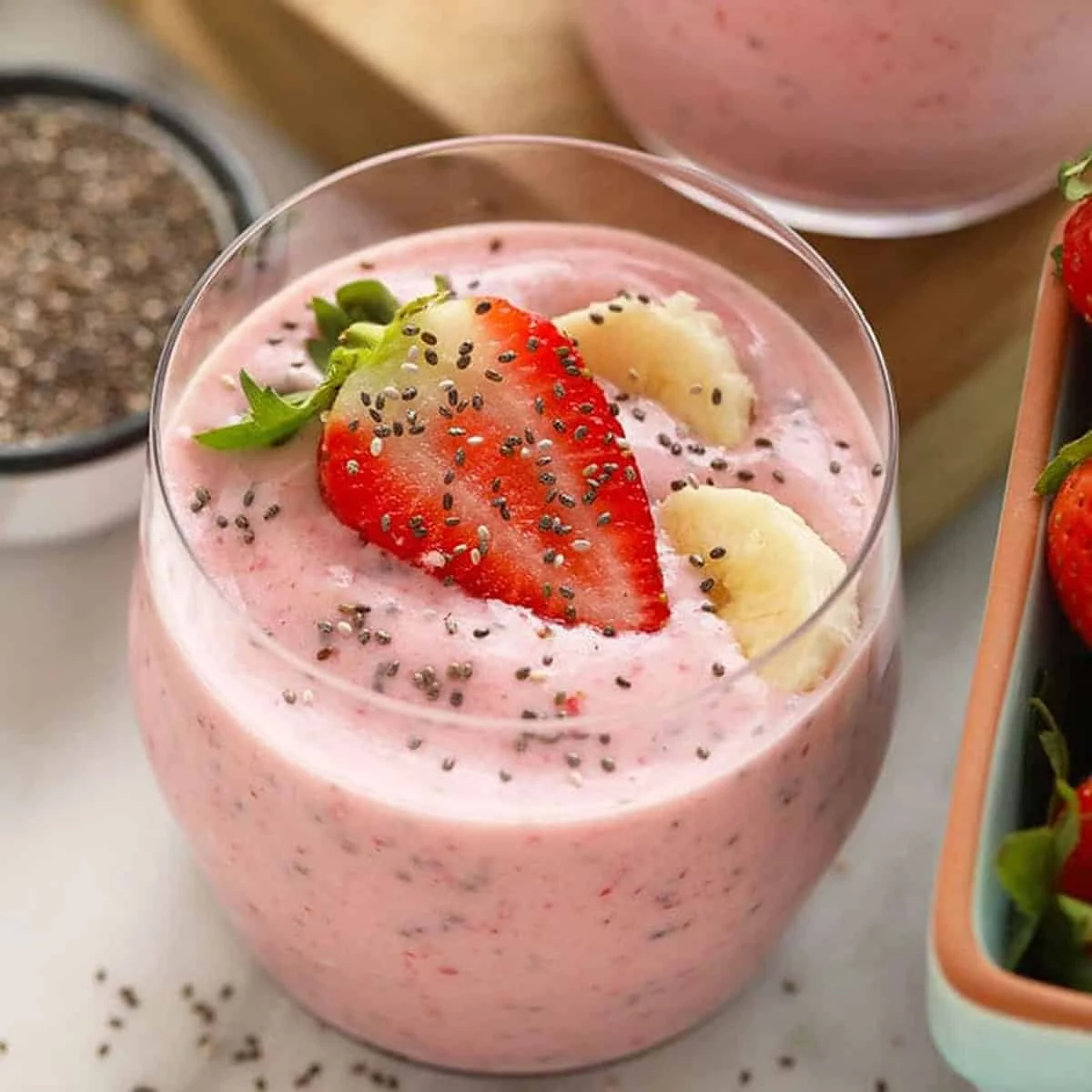 A fruit smoothie garnished with strawberry and banana