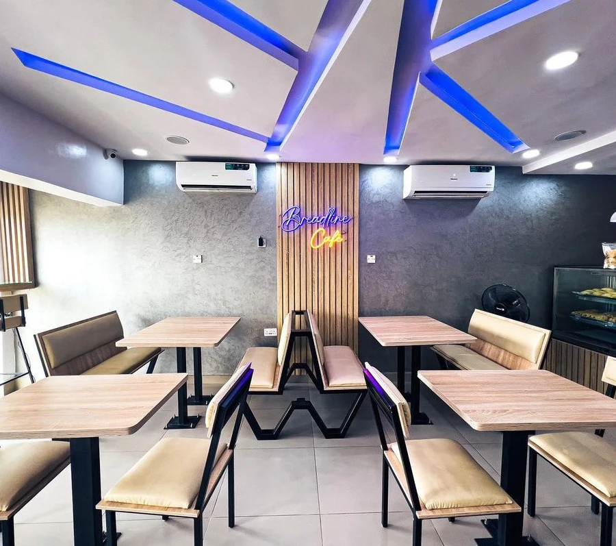The tables, comfortable seating and illuminated Breadline Cafe sign inside our cafe