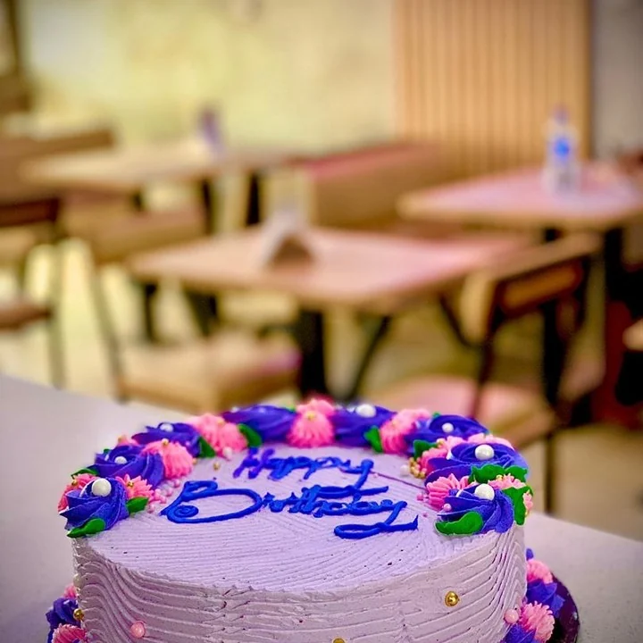 A colourful celebration cake in our cafe